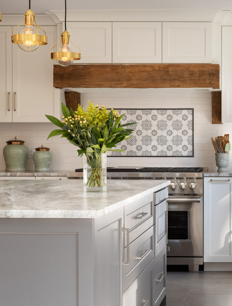 Reclaimed antique barn beam becomes a design detail on the hood. Cabinets by Pennville Custom Cabinetry. 